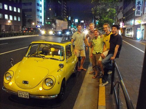 My friends and I with the most exciting cars in Tokyo. I am the second man from right.